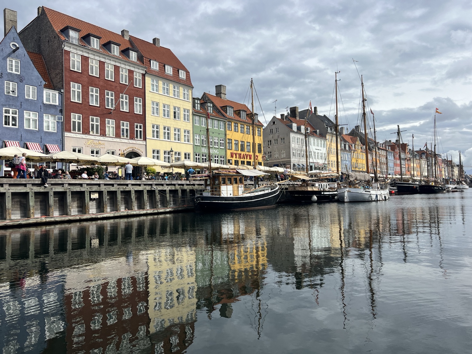 Colorful waterfront buildings reflected in Copenhagen’s harbor
